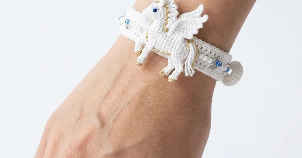 Handmade crochet pegasus bracelet wristband white horse doll on a wrist