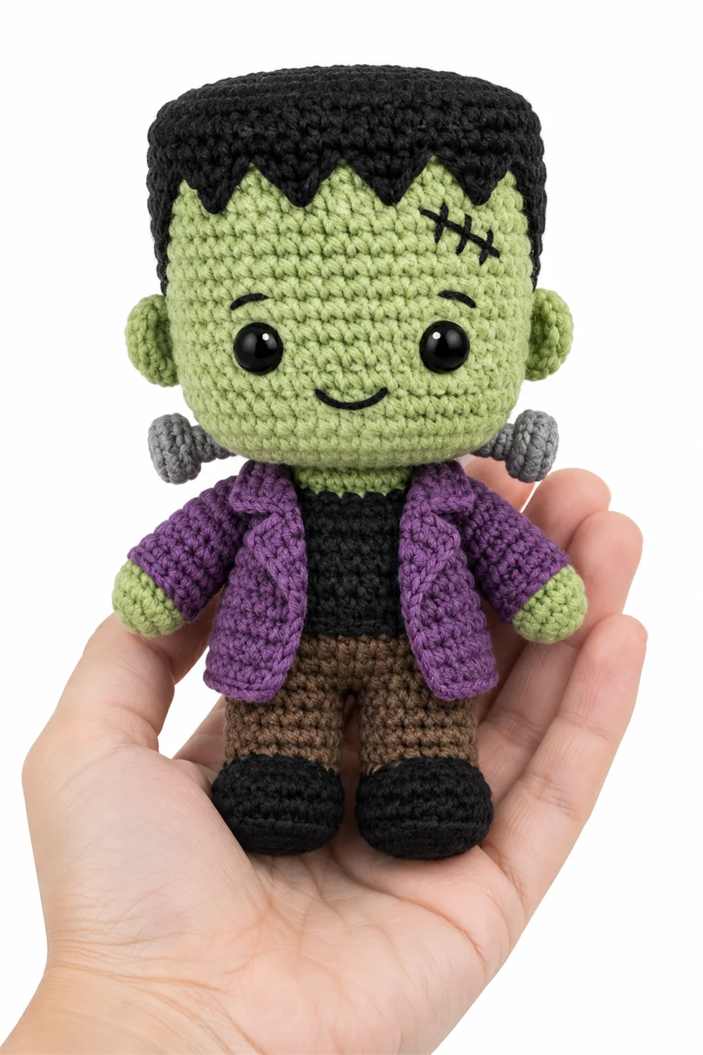 Green crochet stitched monster amigurumi with visible seams
