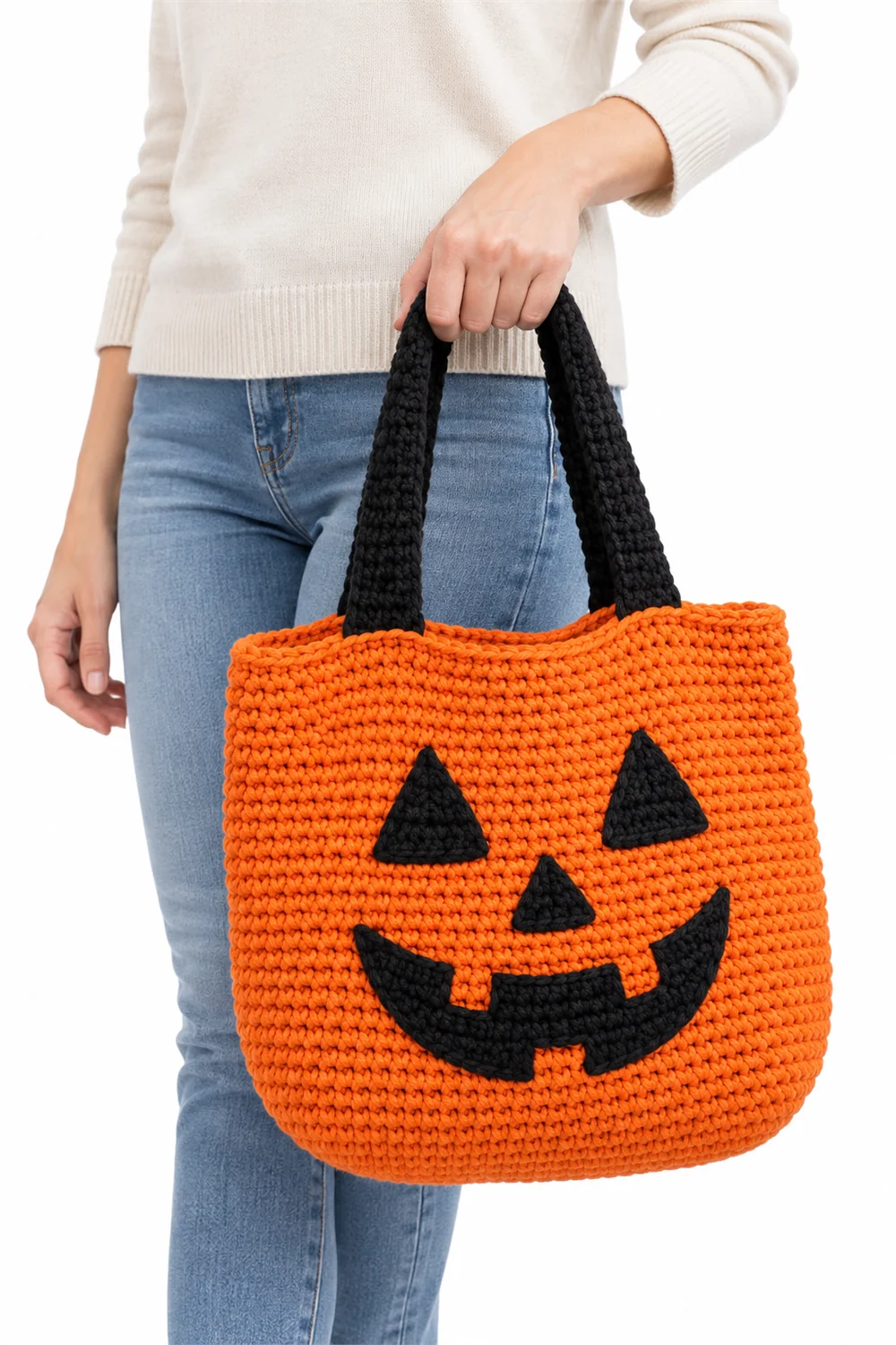Orange crochet jack-o'-lantern treat bag for Halloween