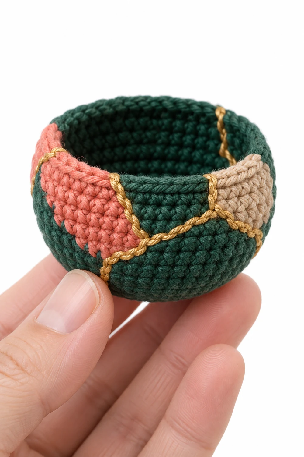 Miniature pine green crochet yarn bowl with raised golden kintsugi seams