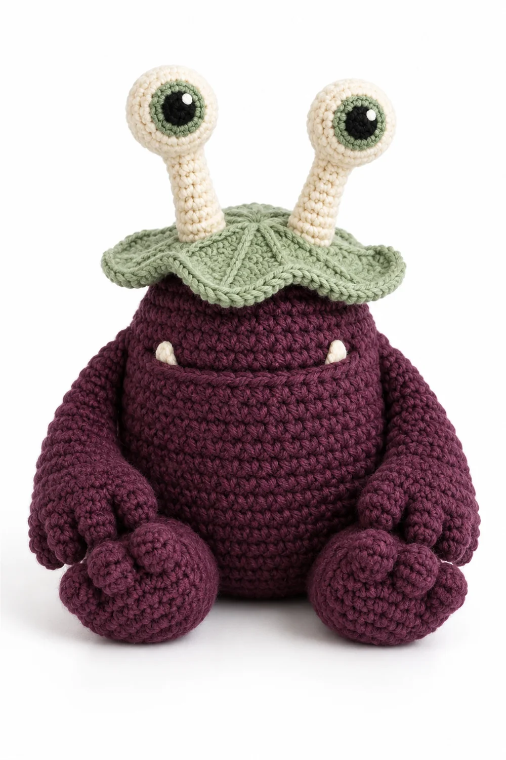 Plum purple crochet swamp monster with lily pad eyes